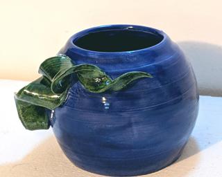 Adorn your home with this bright blue and green vase.