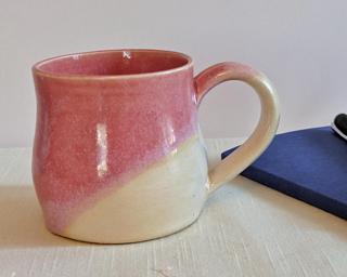 A lovely ceramic mug with unique blend of glazes around the outside.