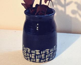 Adorn your home with this one of a kind little carved vase.