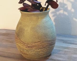 Adorn your home with this one of a kind little carved vase.
