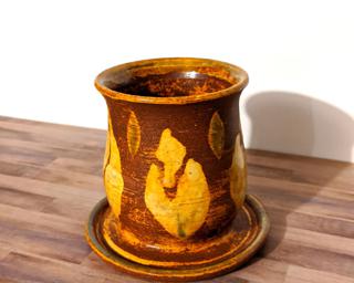 Adorn your home with this one of a kind rustic leaf ceramic planter, complete with a drain hole on the side and a small attached dish to catch any water overflow.
