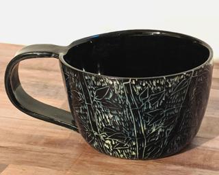 A carefully carved ceramic mug, perfect for a morning latte.