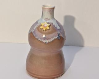 Adorn your home with this blue and brown speckled curvy little bud vase.