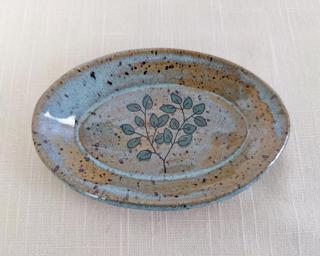 This sweet little dish is made from mid fire brown speckled clay with a light blue glaze, finished with a eucalyptus sprig decal.