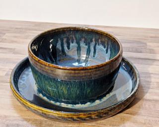 Adorn your home with this one of a kind ceramic planter, complete with a small drain hole on one side (the other one is blocked by glaze) and a wide attached dish to catch any water overflow.