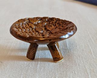 A funny little dish to hold your rings or incense cones.