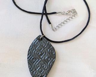 A lovely leaf pendant texture with a geometric imprint.