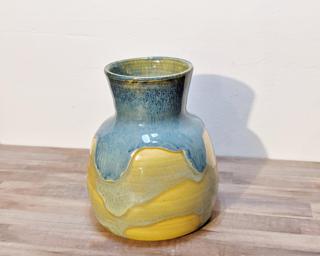 Adorn your home with this one of a kind drippy blue vase.